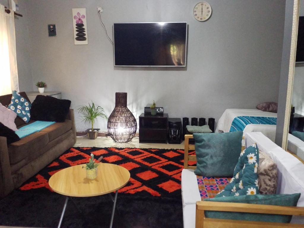 a living room with a couch and a table at Keresia's guestwing in Lusaka