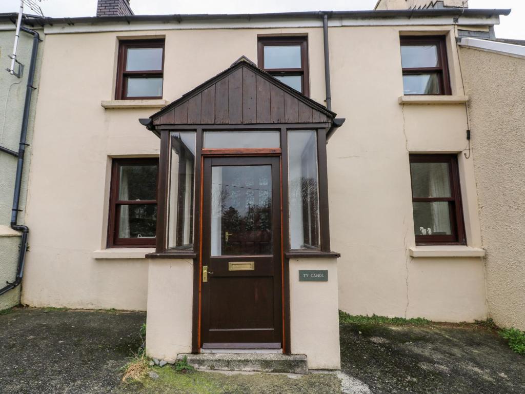 an entry to a house with a wooden door at Ty Canol in Mathry