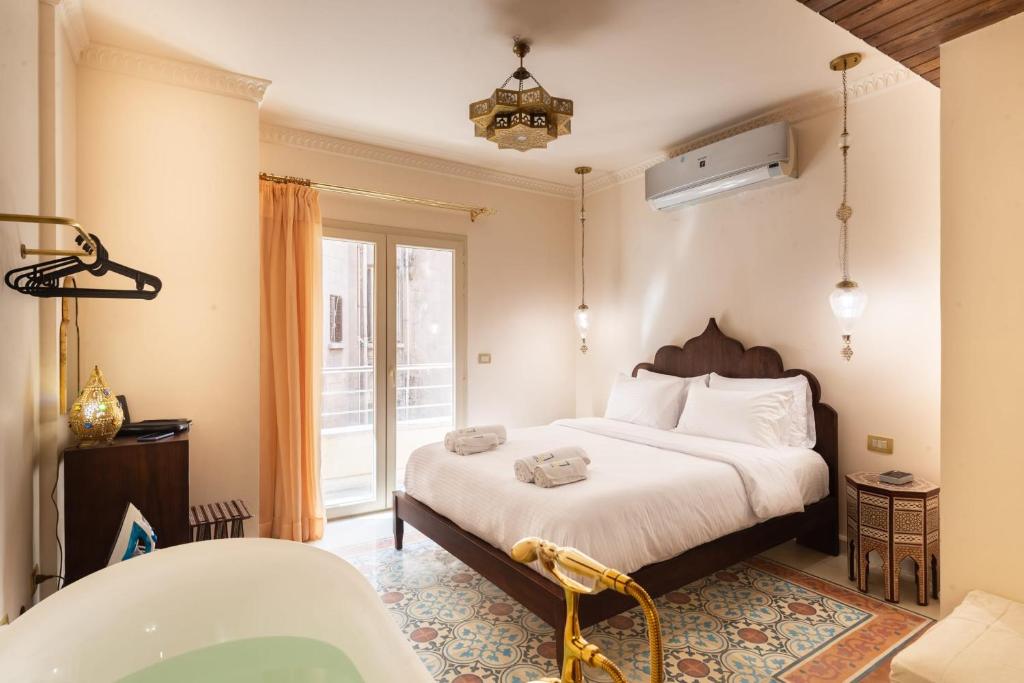 a bedroom with a bed and a bath tub at The Majestic Marrakesh Studio Cairo's Downtown in Cairo