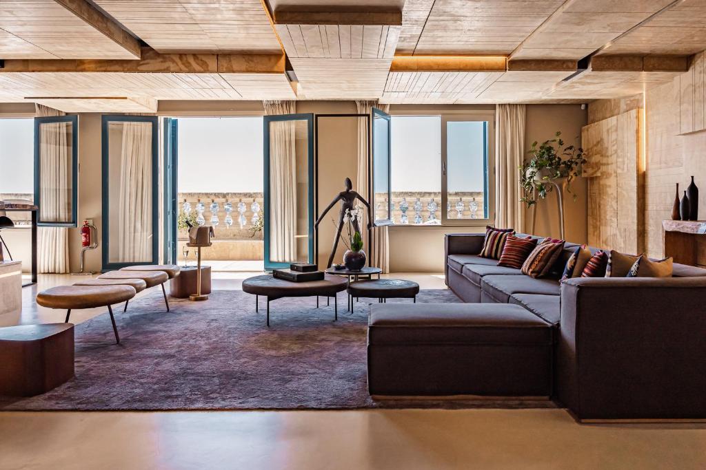 a living room with a couch and a table at Iniala Harbour House in Valletta
