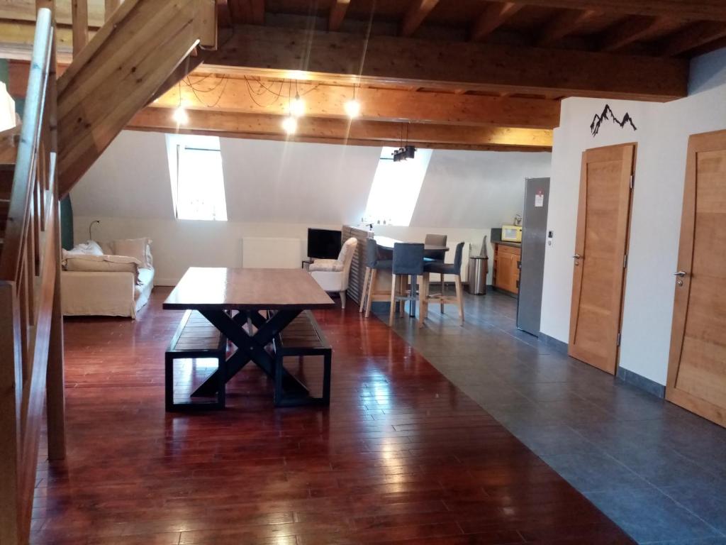 a living room with a table and a dining room at La montagne in Le Bourg-dʼOisans