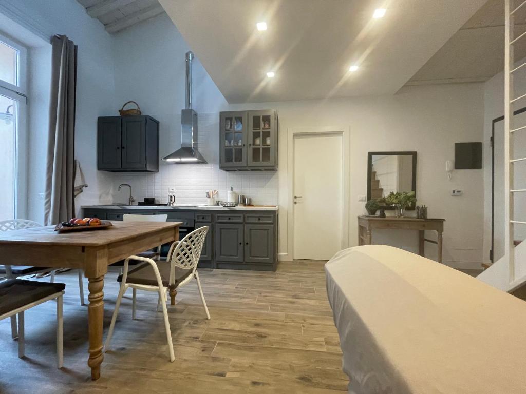 a kitchen and dining room with a table and a bed at Corte Santa Caterina in Florence in Florence