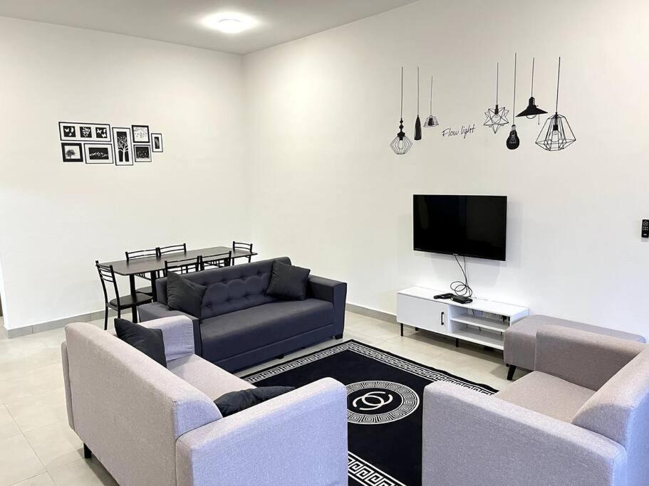a living room with two couches and a tv at Azzalea Homes 6 @ Taman Golden Hills Cameron Highlands in Tanah Rata