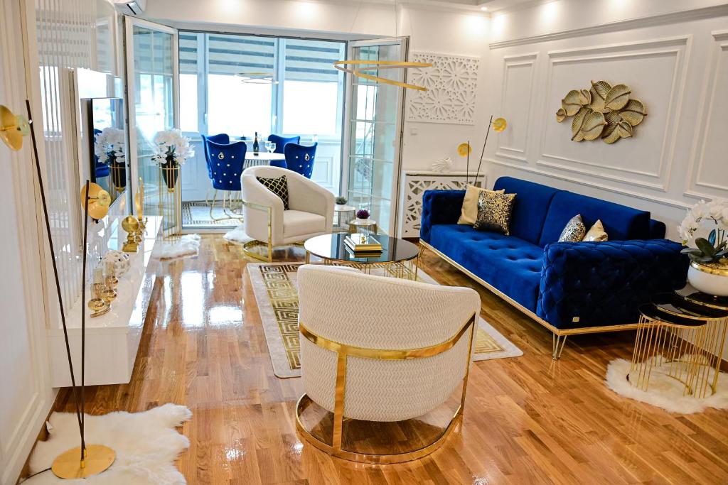 a living room with a blue couch and chairs at Luxury Apartment Karic FREE parking in Tuzla