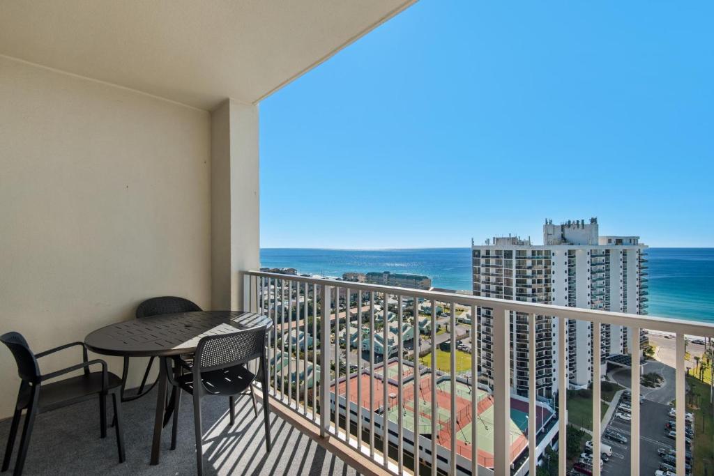 a balcony with a table and chairs and the ocean at Ariel Dunes I 1705 in Destin