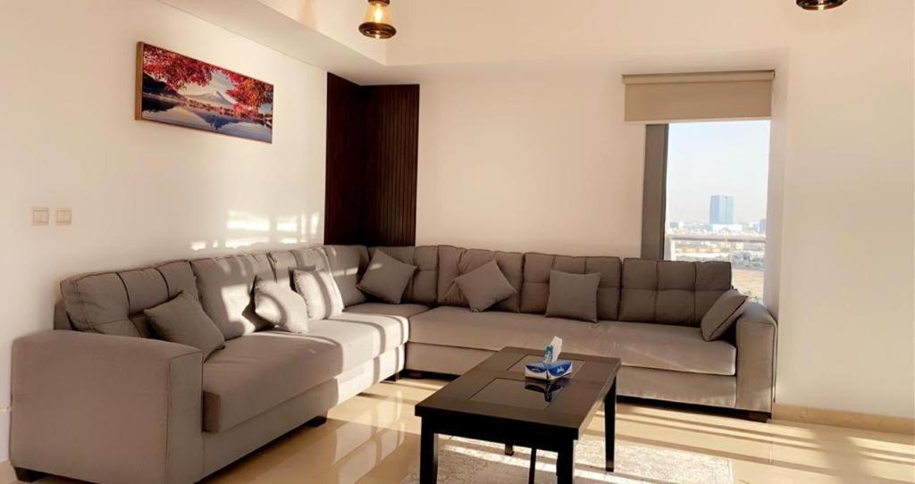 a living room with a couch and a table at Damac Al Jawharah Tower Apartments in Jeddah