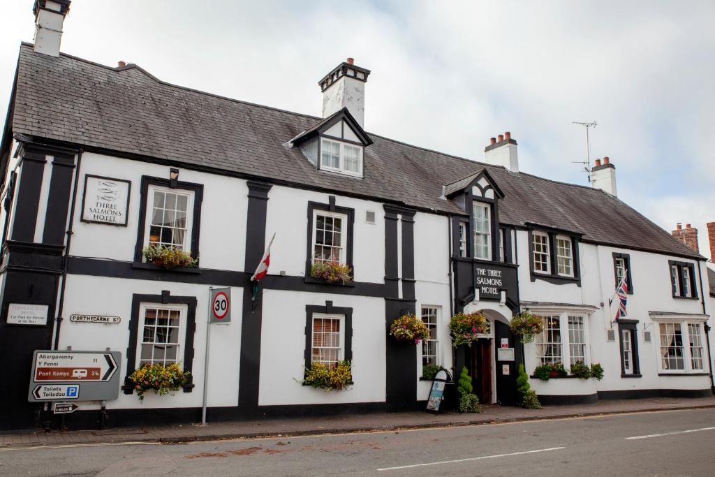 a black and white building on the corner of a street at Three Salmons Hotel in Usk