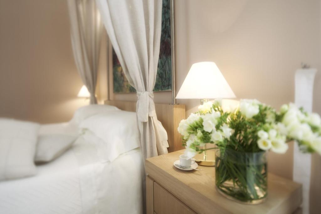 Postel nebo postele na pokoji v ubytování Palazzo Brunaccini Boutique Hotel