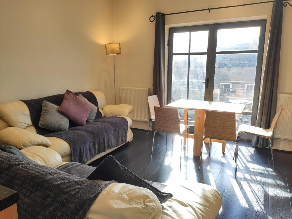 a living room with a couch and a table at City Centre 2 bedrooms 2 Ensuite Flat free parking in Nottingham