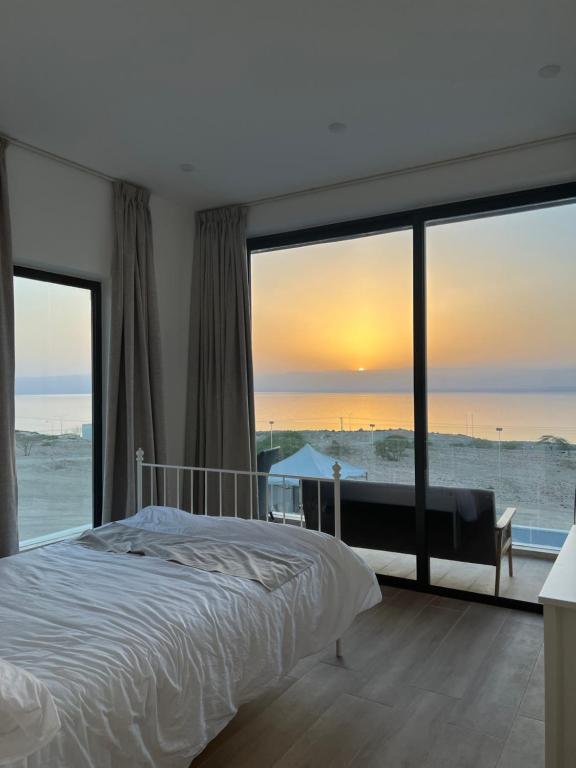 a bedroom with a bed and a view of the ocean at Follow Sea Villa in Sowayma