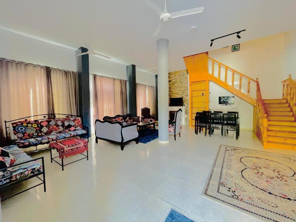 a large living room with couches and a dining room at Ali Luxury Villa in Luxor