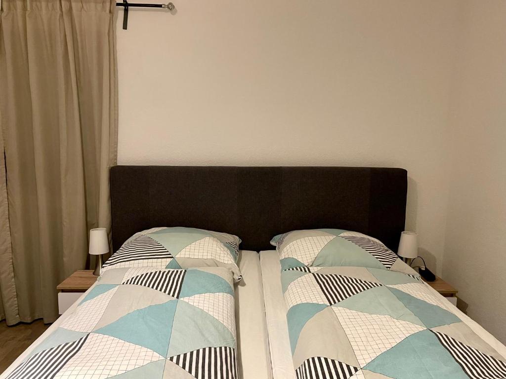 a bedroom with a bed with two pillows on it at Etzel Ferienwohnung (Einzimmerwohnung) in Würzburg