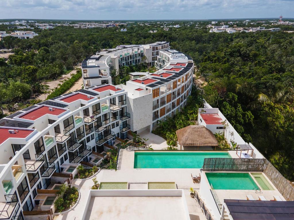 an aerial view of a resort with a swimming pool at The Waves Tulum in Tulum