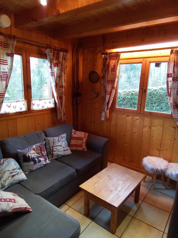 a living room with a couch and a coffee table at Chalet Indépendant " L'anfian-ne" in Les Contamines-Montjoie