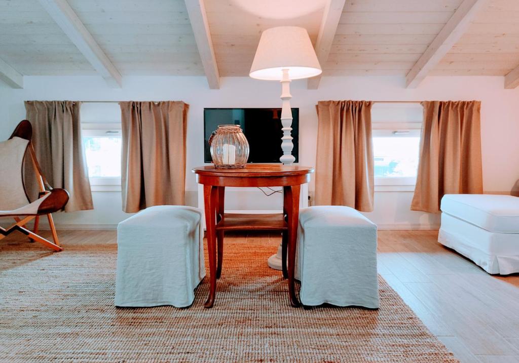 ein Wohnzimmer mit einem Tisch und 2 Stühlen in der Unterkunft Il Cortiletto - Suites & Apartments in Pistoia