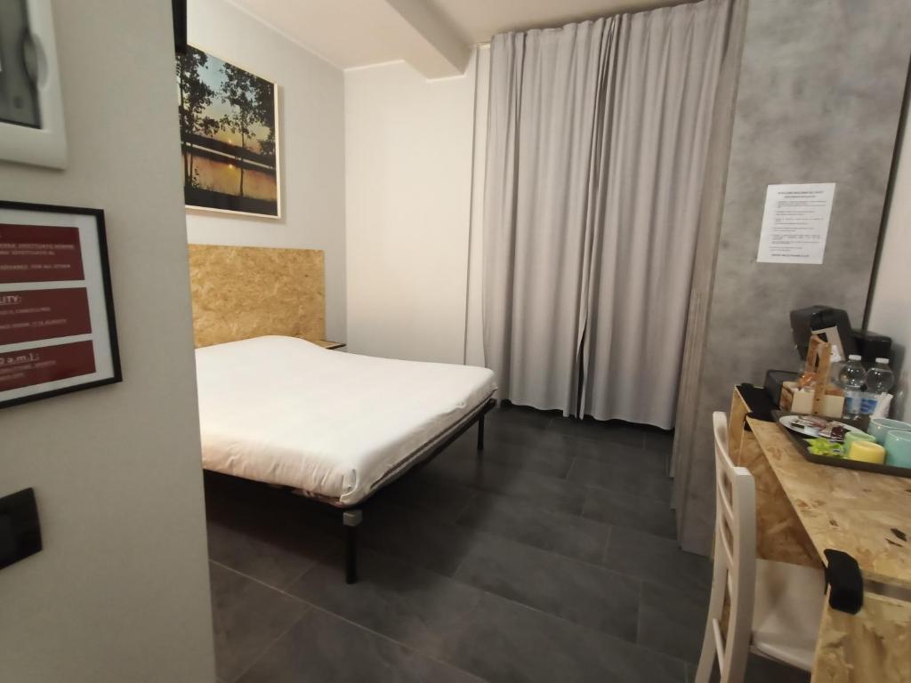 Postel nebo postele na pokoji v ubytování LE MURA Foresteria