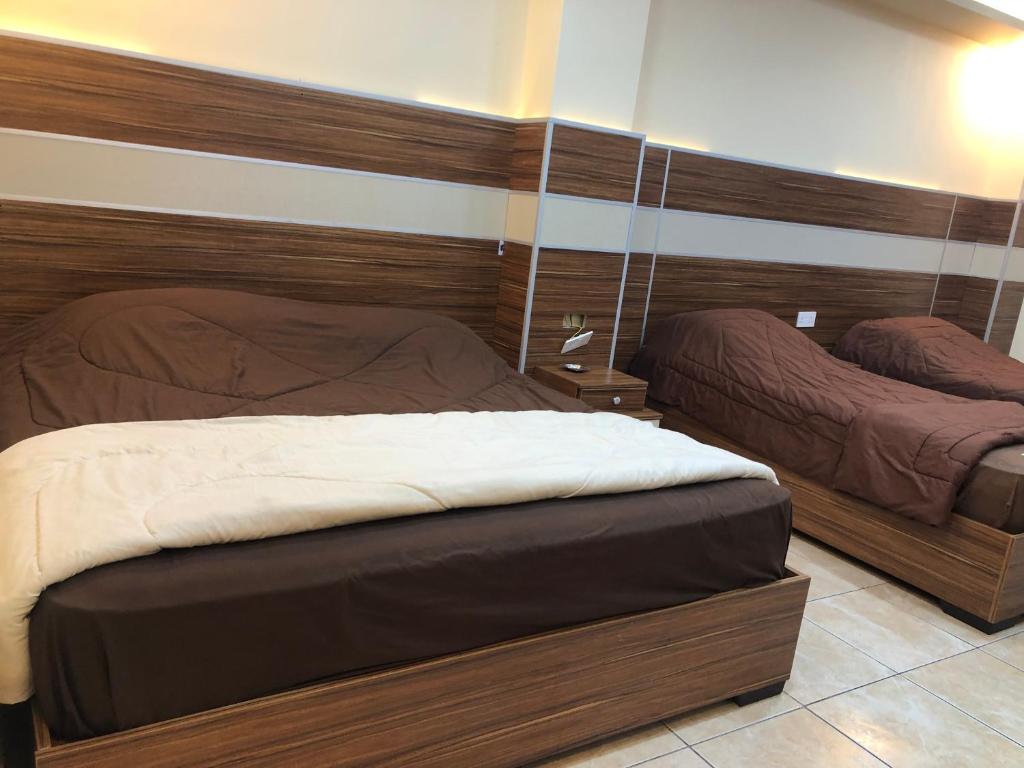 Postel nebo postele na pokoji v ubytování Al Deyafa Hotel