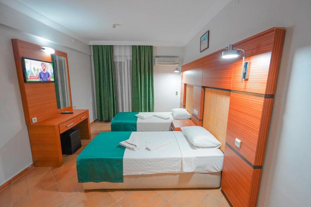 Postel nebo postele na pokoji v ubytování Hotel Amore