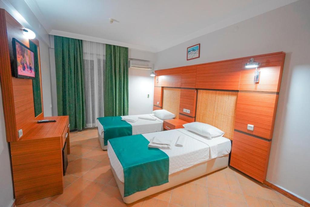 Postel nebo postele na pokoji v ubytování Hotel Amore