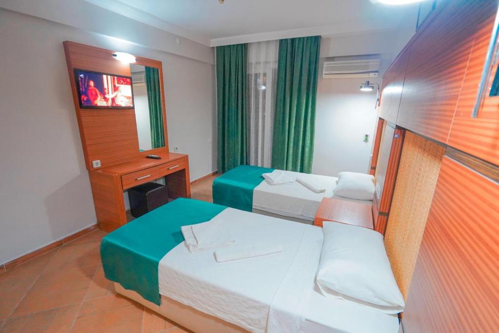 Postel nebo postele na pokoji v ubytování Hotel Amore