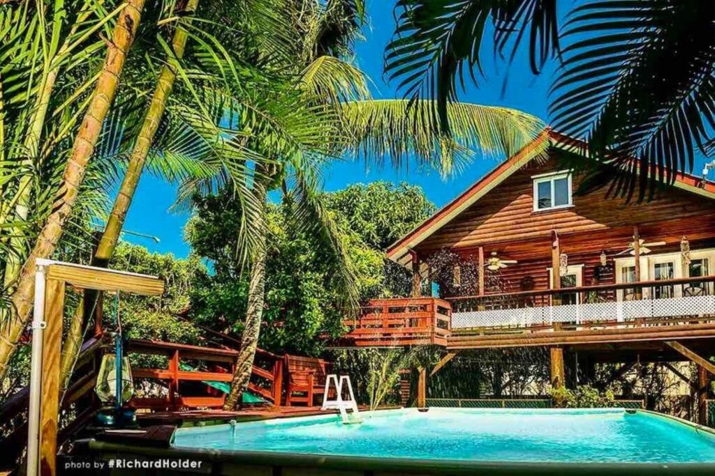 a resort with a swimming pool and a house at CentralCity “Paradise” Private Mini Resort & Pool in Belize City