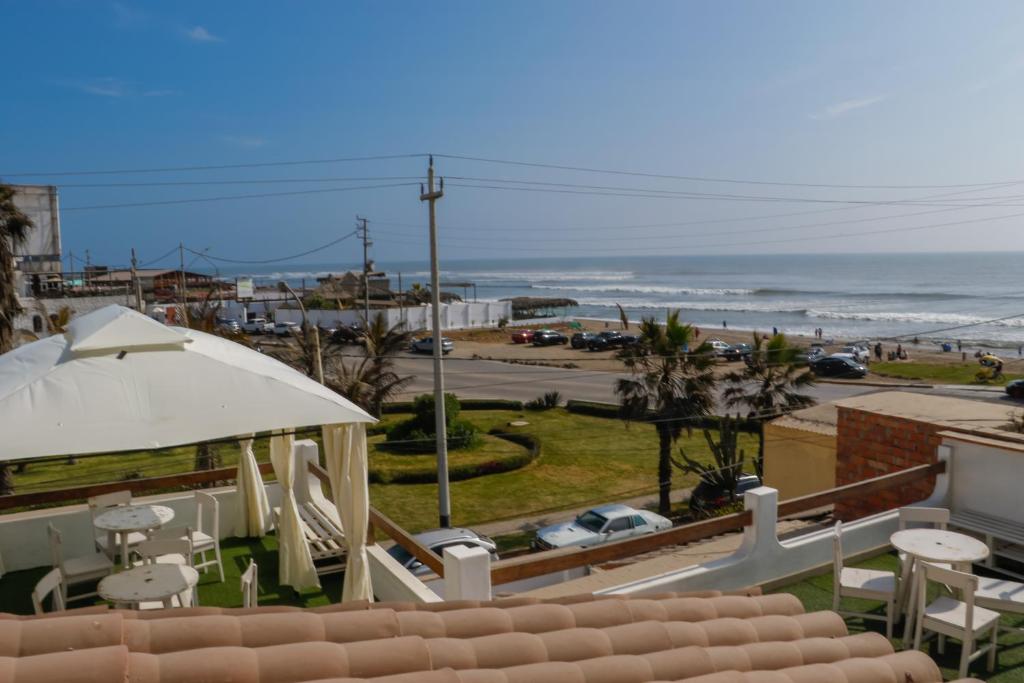 a view of the beach from the balcony of a house at Hospedaje Nuna - Playa Huanchaco in Huanchaco