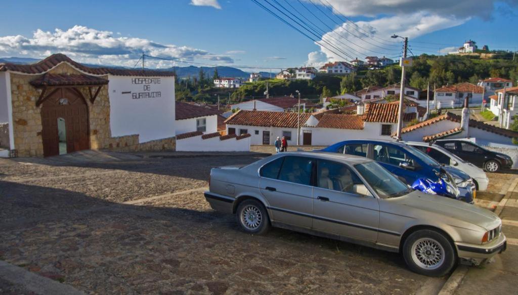 a car parked in a parking lot next to a town at HOSPEDAJE DE GUATAVITA in Guatavita