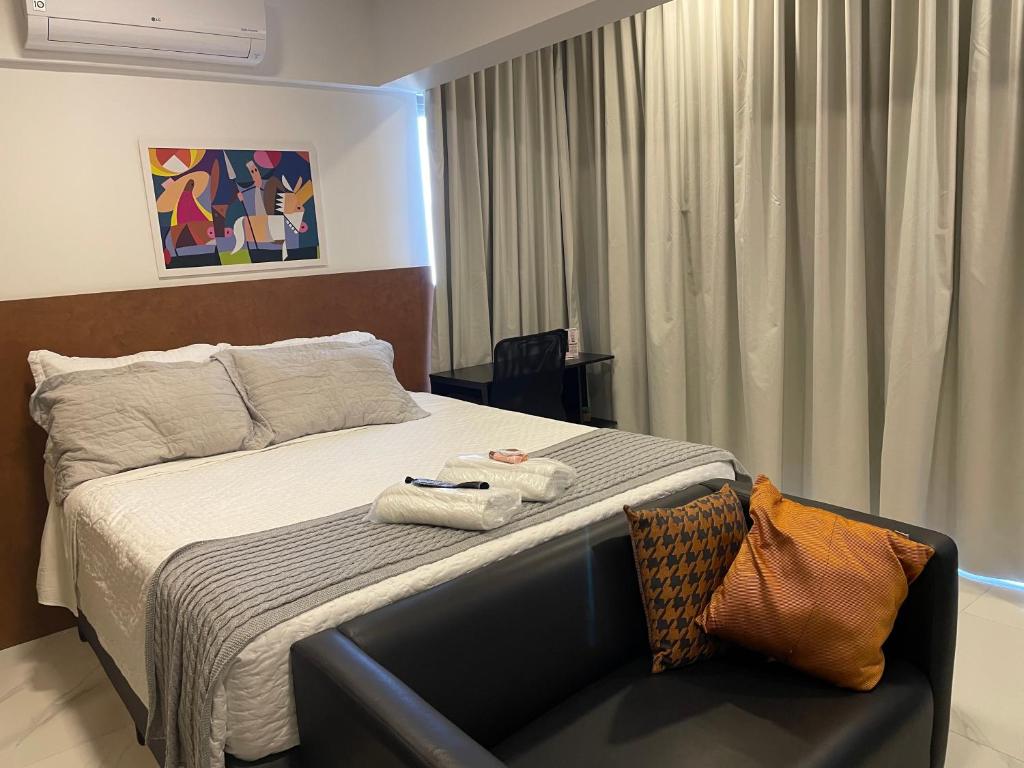 a hotel room with a bed with towels on it at Studio de Luxo Mobiliado Moema in Sao Paulo