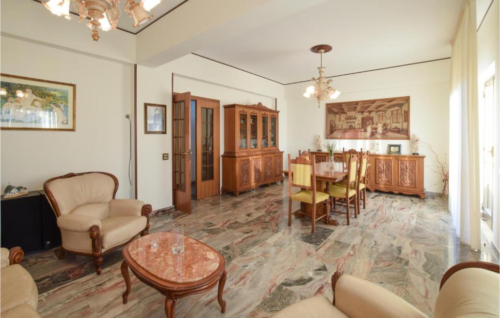 a living room with a table and a dining room at Beautiful Apartment In Reggio Calabria With Wifi And 3 Bedrooms in Reggio di Calabria