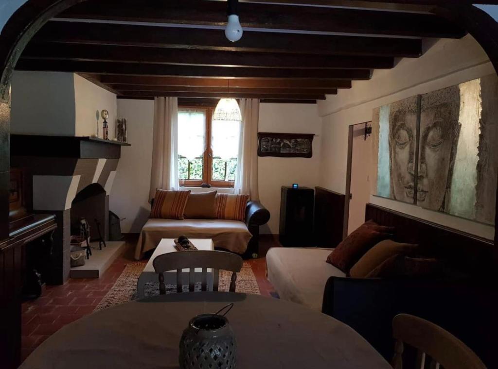 a living room with a couch and a table at Les gîtes du petit mila in Labrit