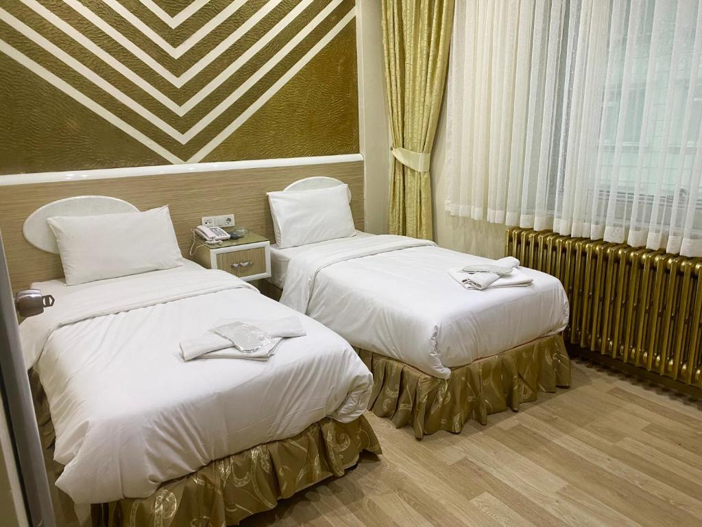 Postel nebo postele na pokoji v ubytování Grand Oral Hotel