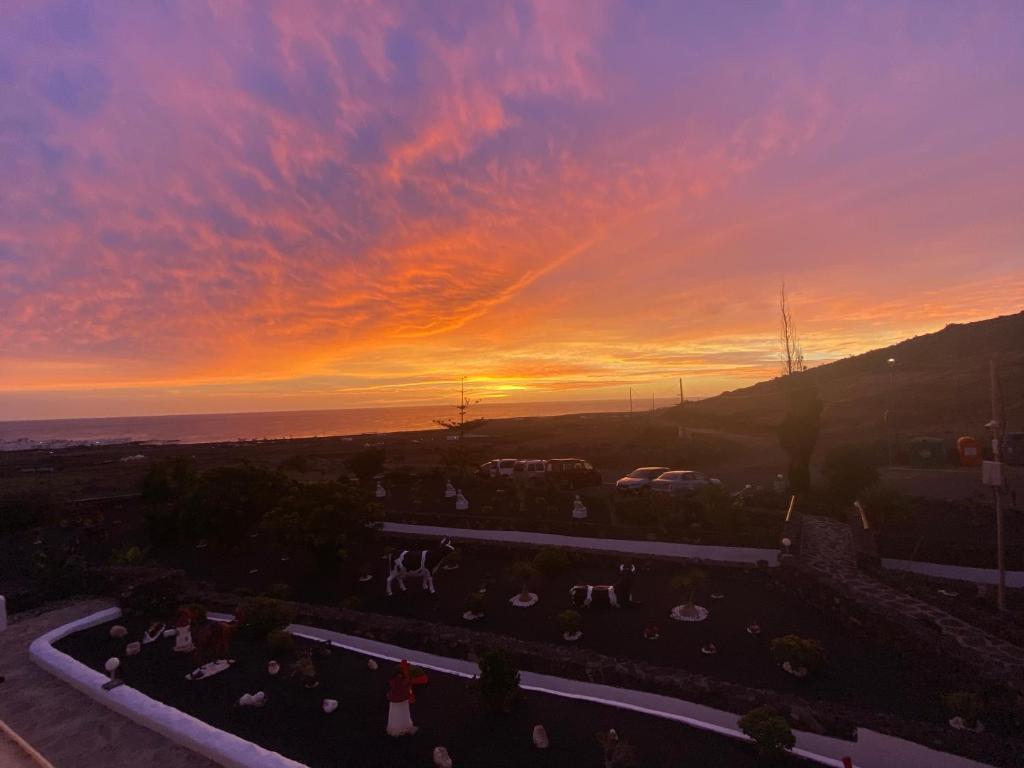 a sunset view from the balcony of a building at Club JM Lanzarote in Tabayesco