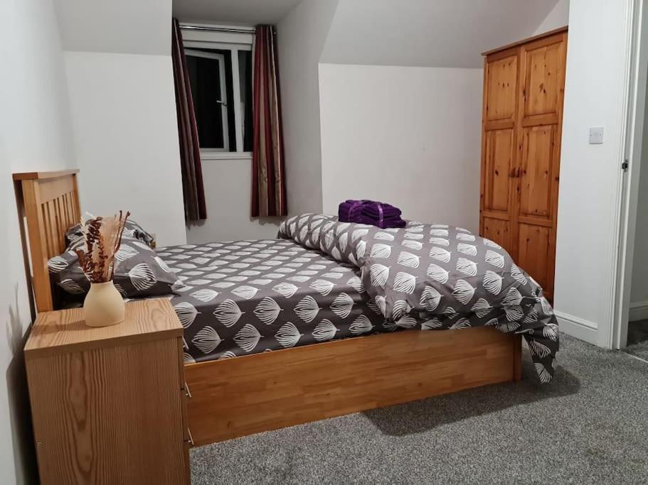 a bed sitting in a room with at Impeccable 4-Bed House Near Manchester City Centre in Manchester