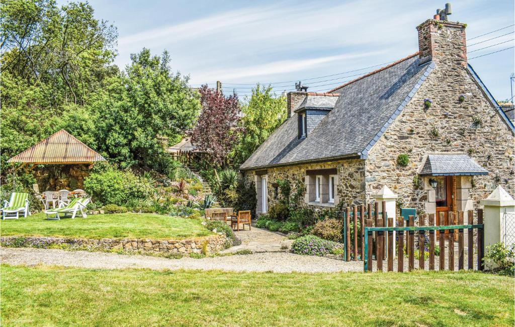 an old stone house with a garden in front of it at Holiday Home Rue Jarl Priel in Plouguiel