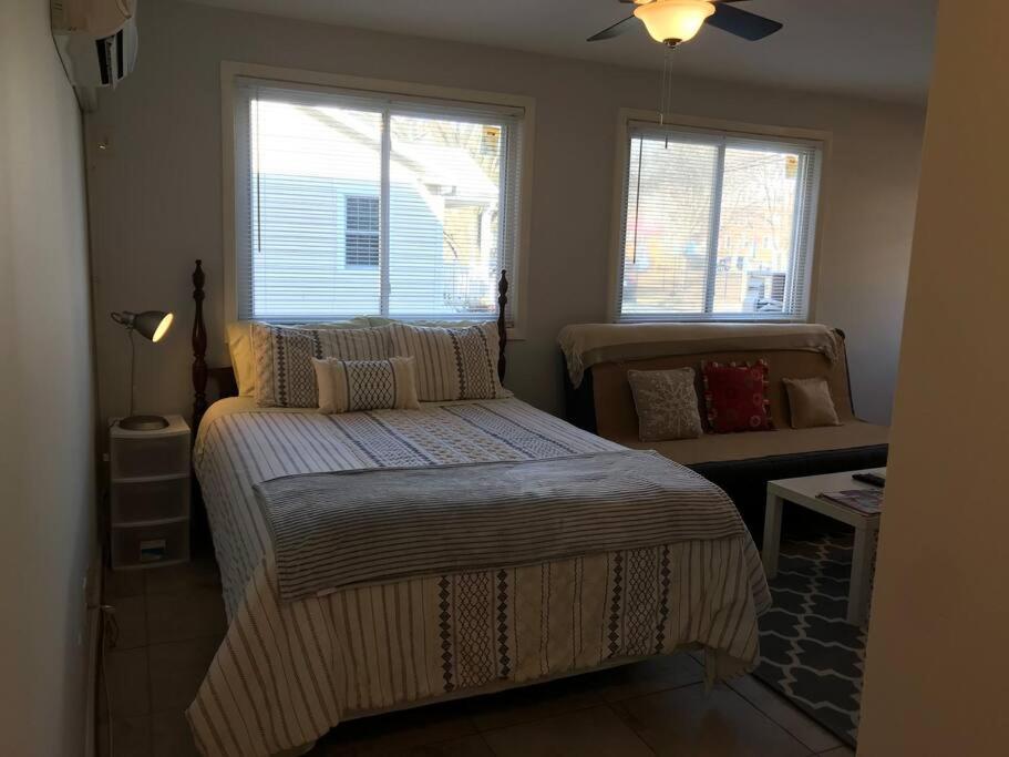 a bedroom with a bed and two windows at Walk2Metro's,DCGem,Private,Wifi, FreeParking in Arlington