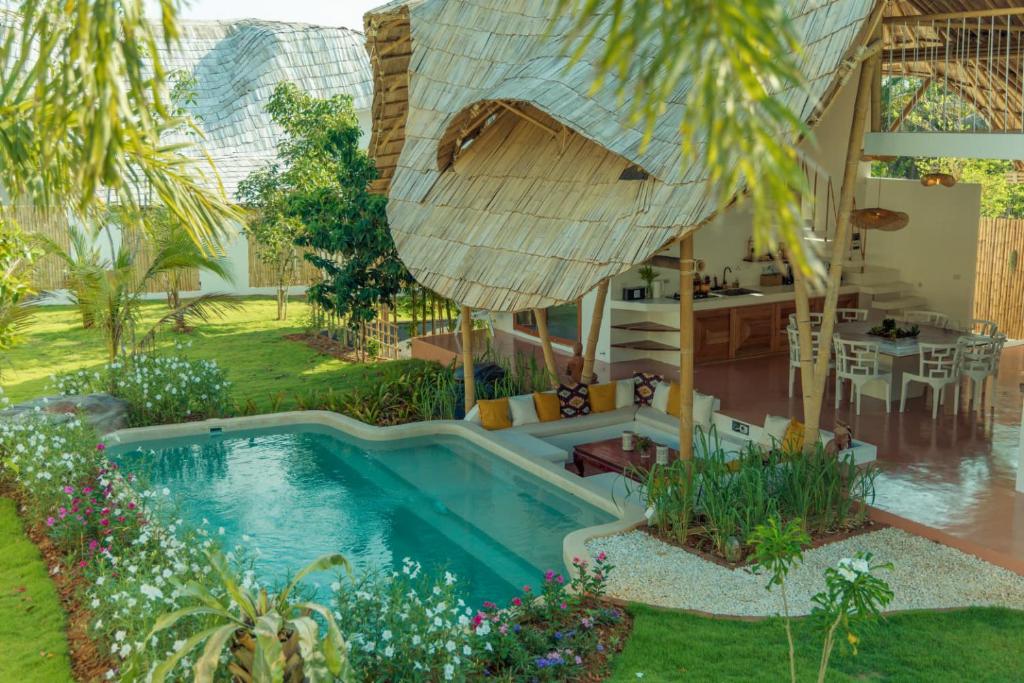 a backyard with a swimming pool and a house at Aloe Ecological Boutique Villa 2 in Ao Nam Mao