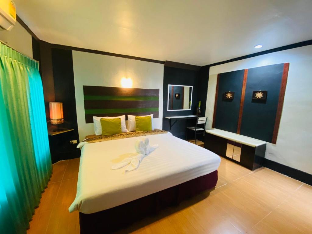 Pakor Boutique Resort في فانجنجا: غرفة نوم عليها سرير مع وردة بيضاء