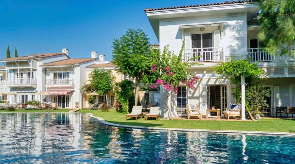 a house with a swimming pool in front of a house at Portville Villa 45 in Göcek