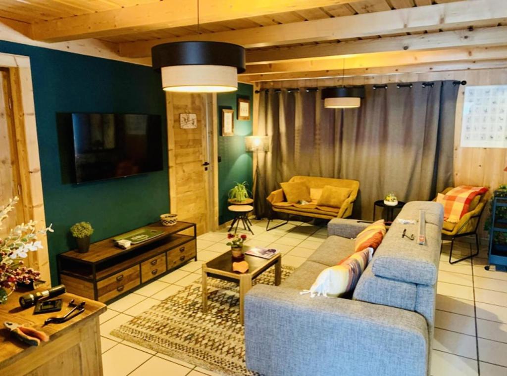 a living room with two blue chairs and a television at Apartment in Morzine - Ski In - Sleeps 6 in Morzine