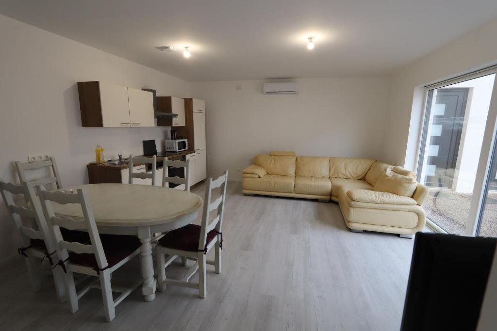 a living room with a table and a couch at Homeday FERME KLEIN in Haguenau