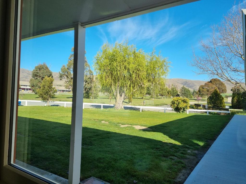a view from a window of a yard at Home Away from Home - Waitaki Lakes Apartment A5 in Otematata
