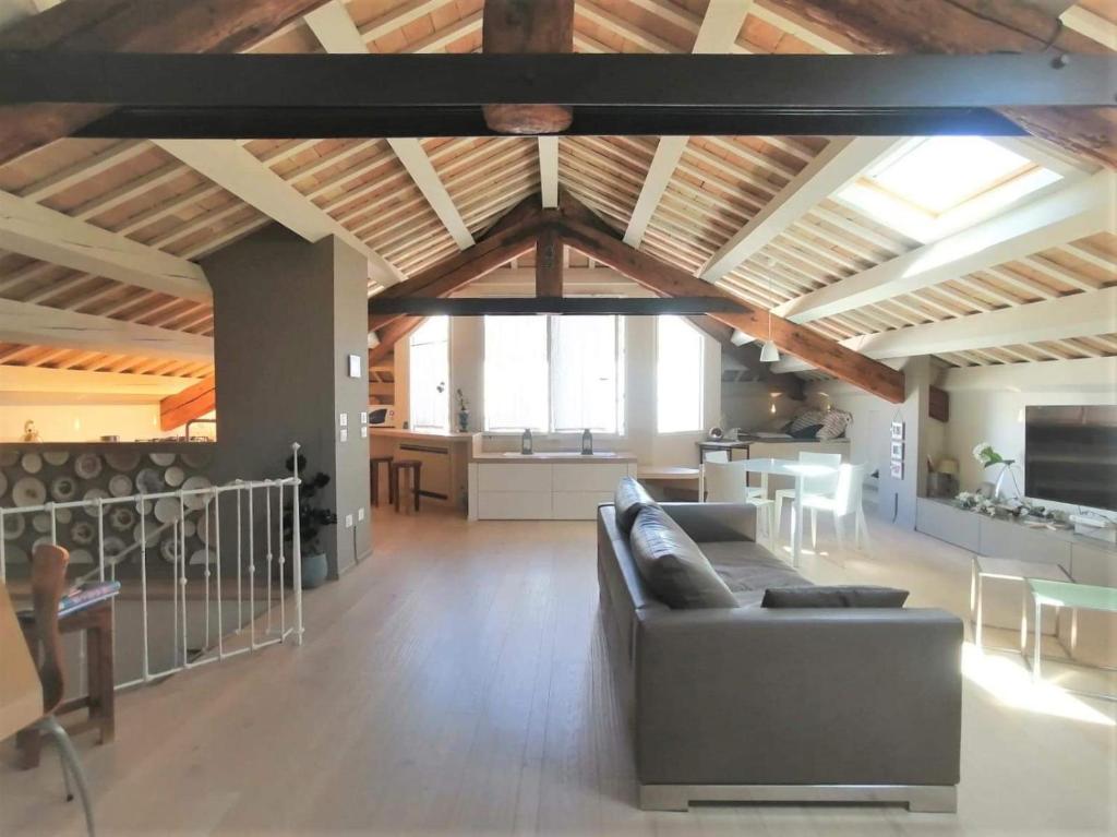 a large living room with a couch and a kitchen at CasaDei Home Design & Relax in Cervia