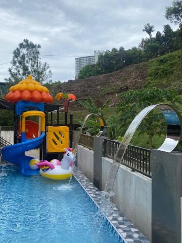a water park with a ride in a pool at Villa 16pax 3BR with Spa Pool n Pool Table near SPICE ARENA in Bayan Lepas