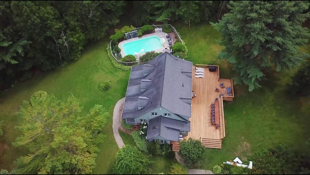 an overhead view of a house with a swimming pool at Marmora Retreat - Unique Waterfront Farmhouse in Marmora