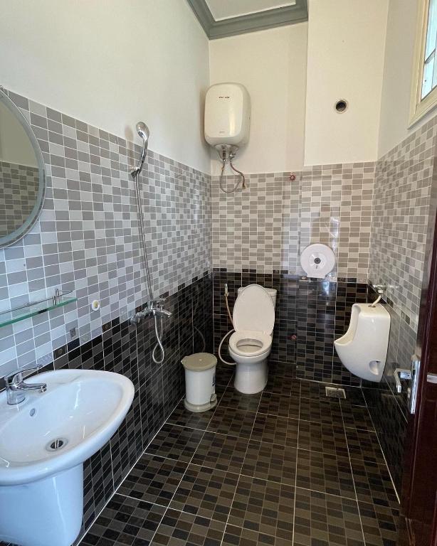 a bathroom with two toilets and a sink at Dalat Friendly Fun in Da Lat