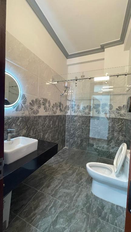 a bathroom with a toilet and a sink at Dalat Friendly Fun in Da Lat
