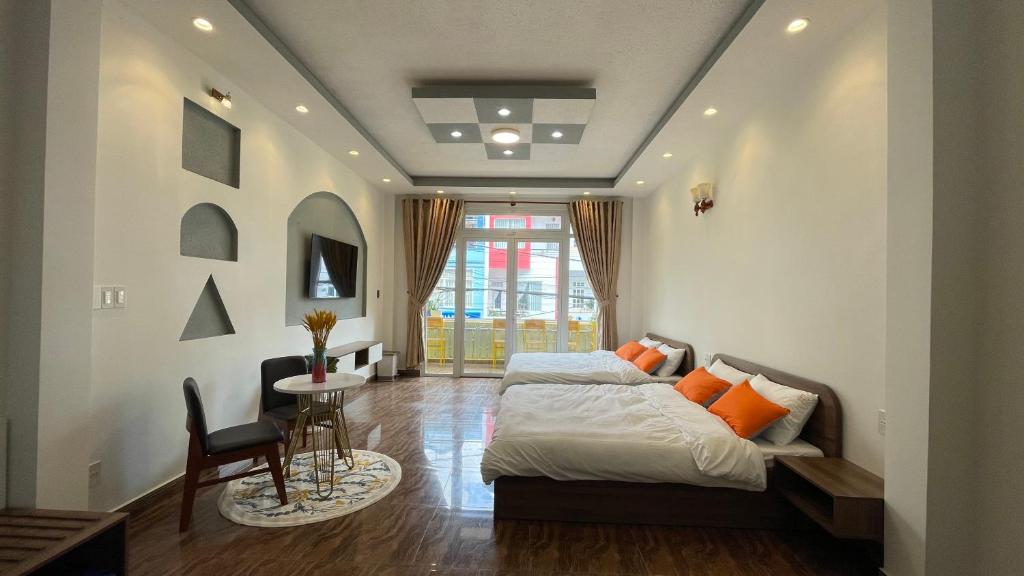 a bedroom with a bed and a table and a chair at Dalat Friendly Fun in Da Lat