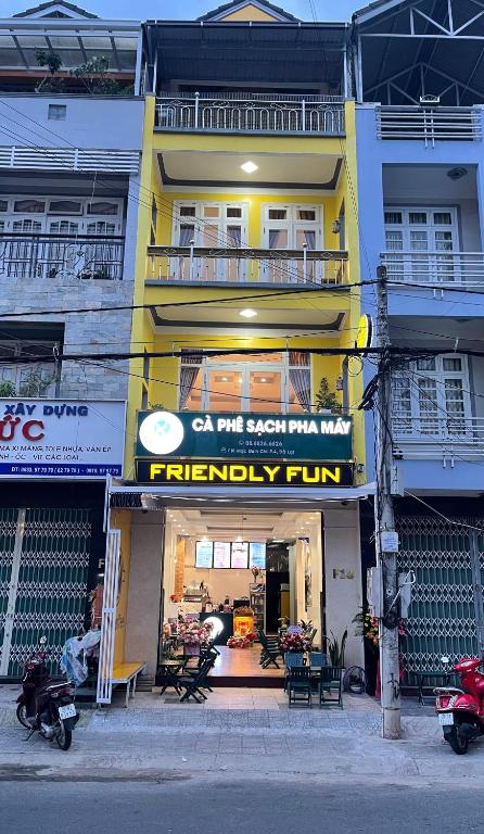 a yellow building with a fidelity run sign on it at Dalat Friendly Fun in Da Lat