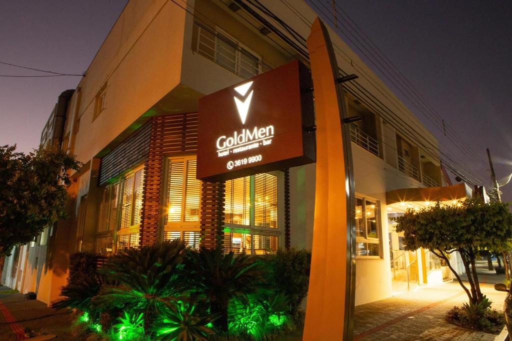 a building with a sign in front of it at Goldmen Hotel in Cianorte