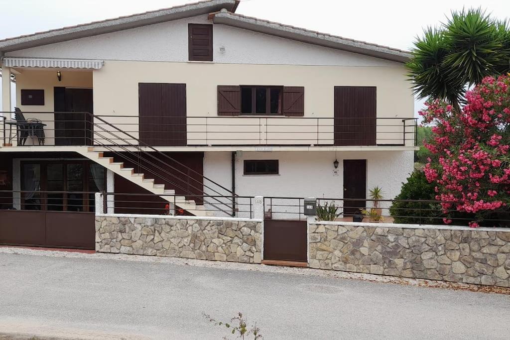 a white house with a balcony and a fence at Casa Calado in Cadima